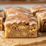 Moist apple fritter cake sliced open showing apple chunks and cinnamon layers