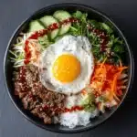 Dol Sot Bi Bim Bap in hot stone bowl with colorful vegetables and beef bulgogi