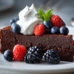 Gluten-free chocolate quinoa cake slice with berries and whipped cream