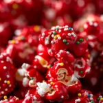 Close-up of red velvet popcorn with sprinkles on parchment paper