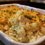 Delicious chicken rice casserole topped with cheese and herbs, perfect for family meals.