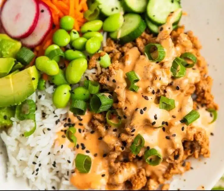 Ground turkey rice bowls with spicy bang bang sauce and fresh vegetables