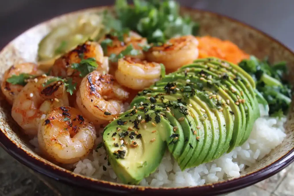 Shrimp & Avocado Bowl in a ceramic plate with lime