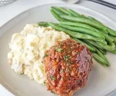 Mini turkey meatloaves served with vegetables on a plate