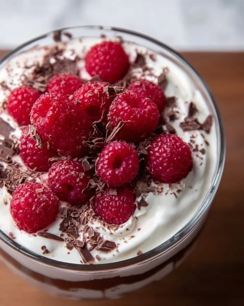 Delicious Raspberry Chocolate Trifle layered with chocolate mousse and fresh raspberries.