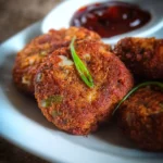 Delicious bread cutlet served on a plate with condiments