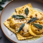 Plate of homemade butternut squash ravioli with sage butter sauce