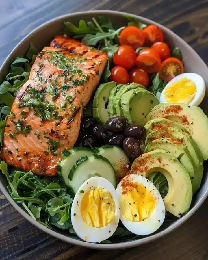 Delicious Mediterranean salmon power bowl with fresh vegetables and grains