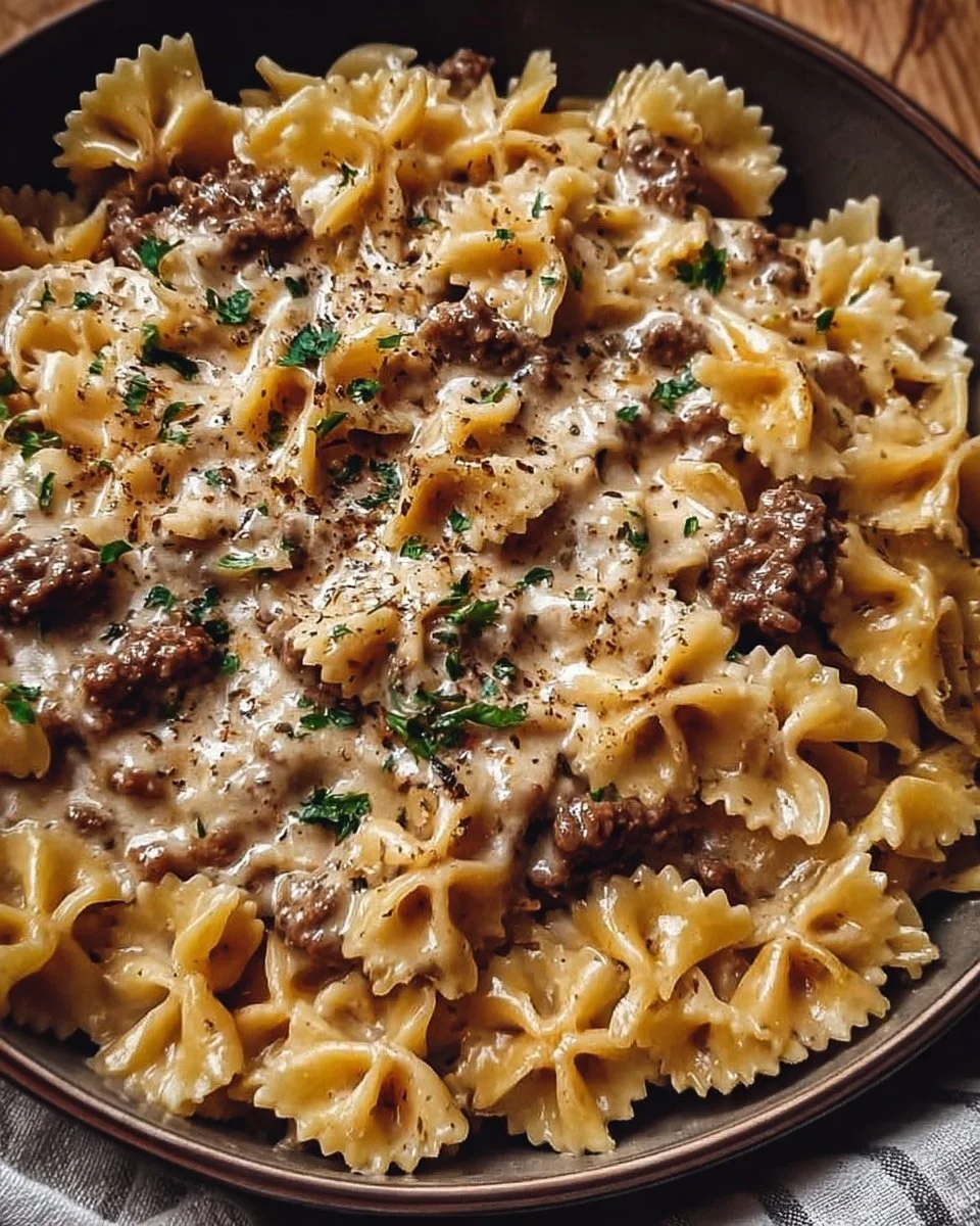 A delicious plate of creamy beef pasta garnished with herbs