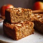 Slice of easy breakfast oatmeal apple cake with apples and oats