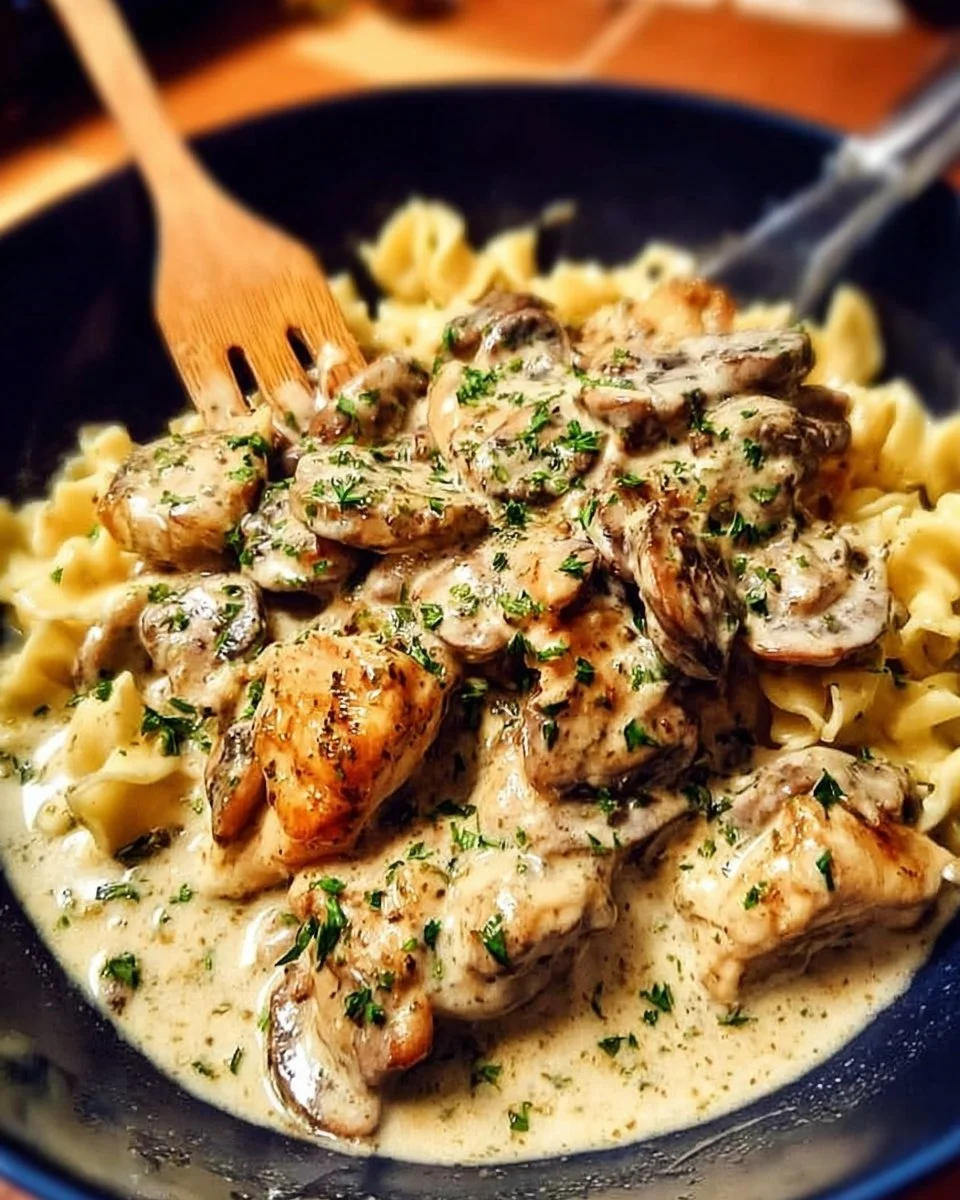 Delicious plate of rich chicken stroganoff served with noodles and garnished.