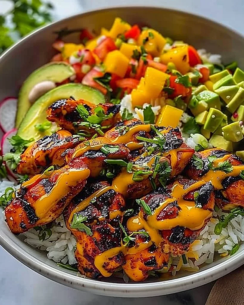 Grilled maple sriracha chicken bites with coconut rice and mango avocado salsa