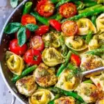 Delicious one-pan pesto chicken with tortellini and colorful veggies