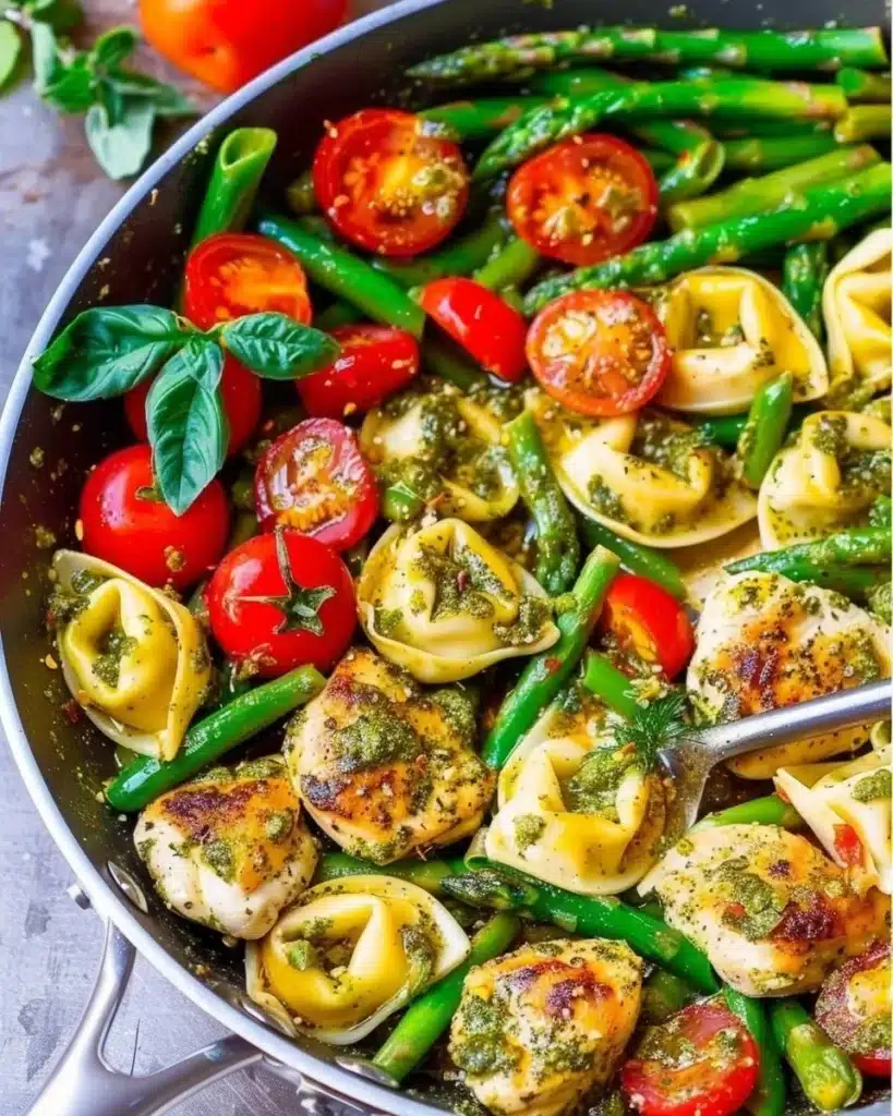 Delicious one-pan pesto chicken with tortellini and colorful veggies