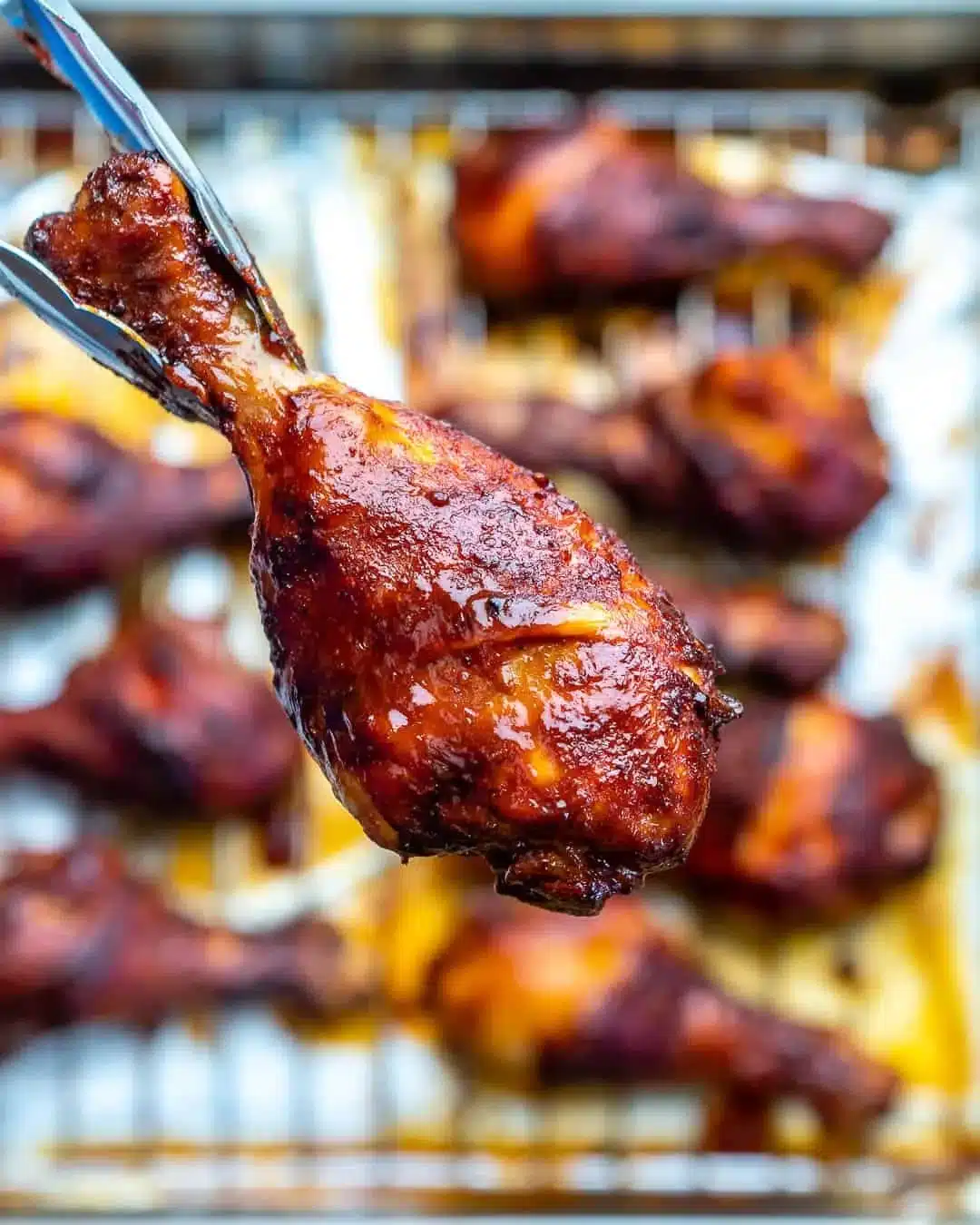 Baked BBQ Chicken Drumsticks garnished with herbs and served on a plate