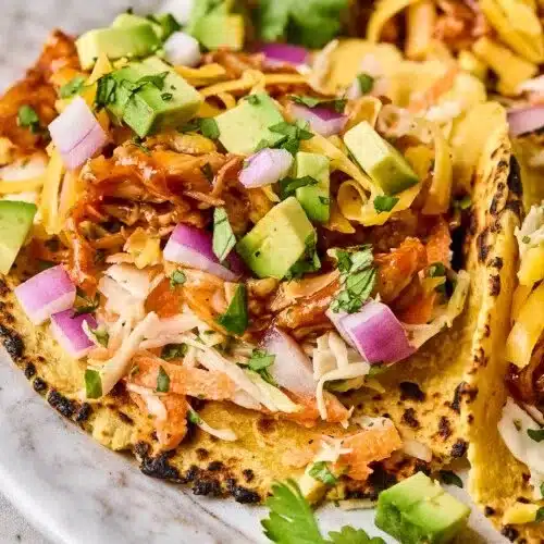 Delicious BBQ chicken tacos served with fresh toppings and garnishes