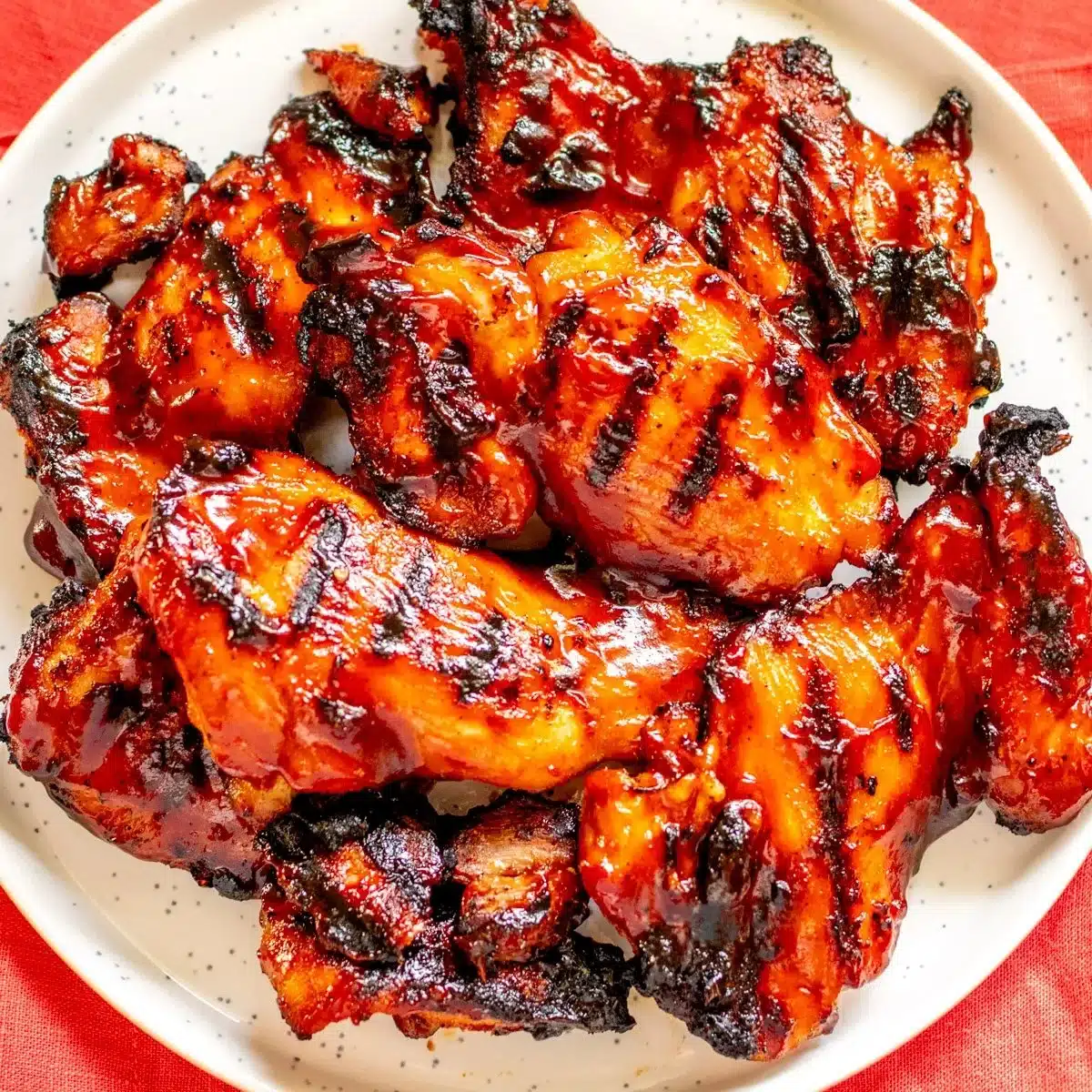 Delicious BBQ chicken thighs on the grill, ready to serve.
