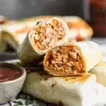 Crispy BBQ chicken wraps filled with fresh ingredients and drizzled with barbecue sauce.