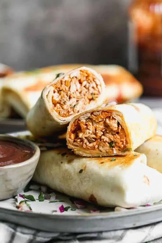 Crispy BBQ chicken wraps filled with fresh ingredients and drizzled with barbecue sauce.
