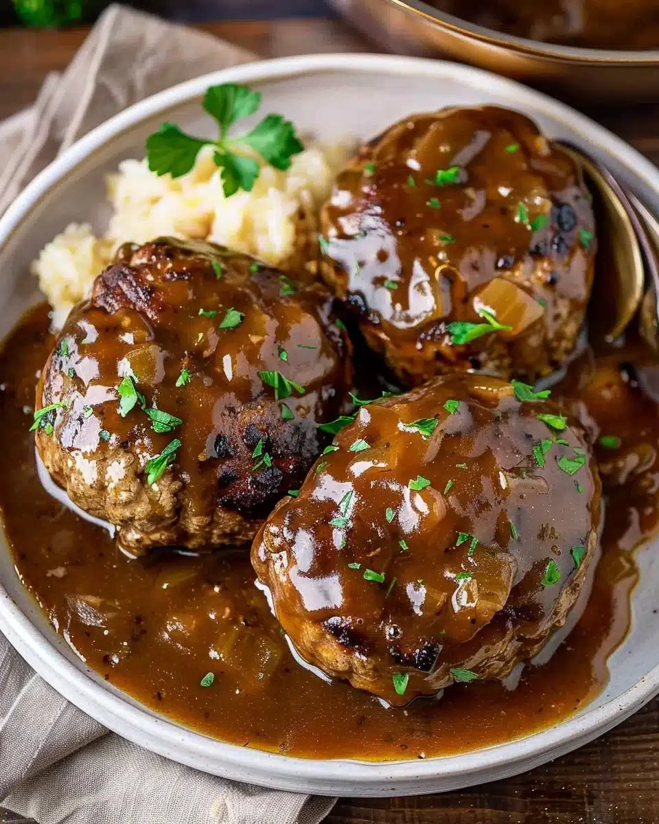 Delicious easy slow cooker Salisbury steaks served with gravy and mashed potatoes.