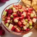 Fruit salsa served with cinnamon sugar tortilla chips for a delicious snack.