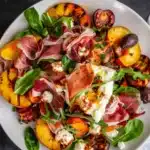 Grilled nectarine burrata prosciutto salad with vibrant colors and fresh ingredients
