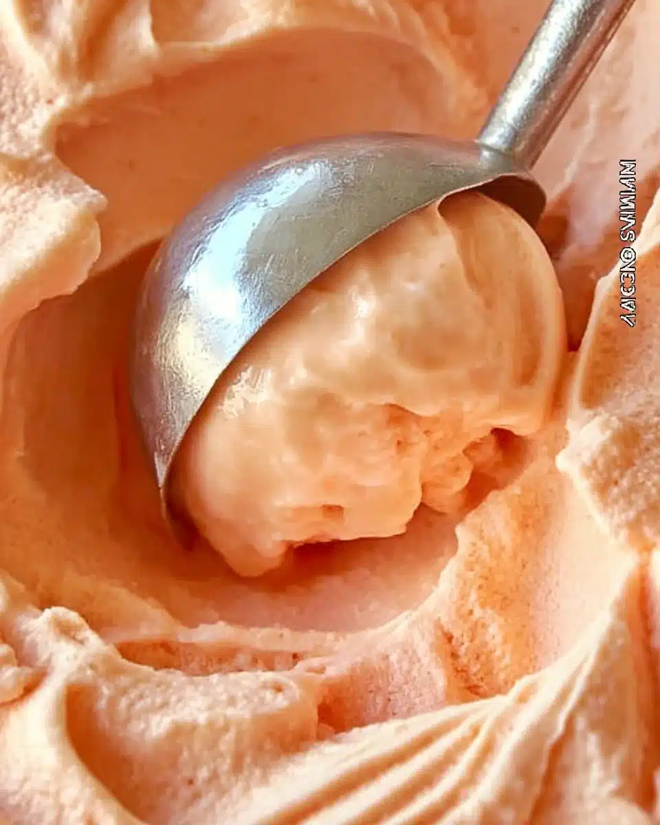 Creamy nectarine frozen yogurt in a bowl with fresh nectarines