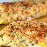 Parmesan Crusted Baked Mahi Mahi on a plate, garnished with herbs.