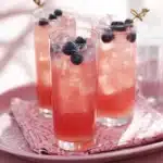 A refreshing glass of homemade rhubarb lemonade adorned with fresh mint leaves.