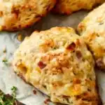 Freshly baked savory ham and cheese scones on a wooden table
