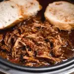 Delicious slow cooker BBQ pulled pork served in a sandwich with coleslaw.
