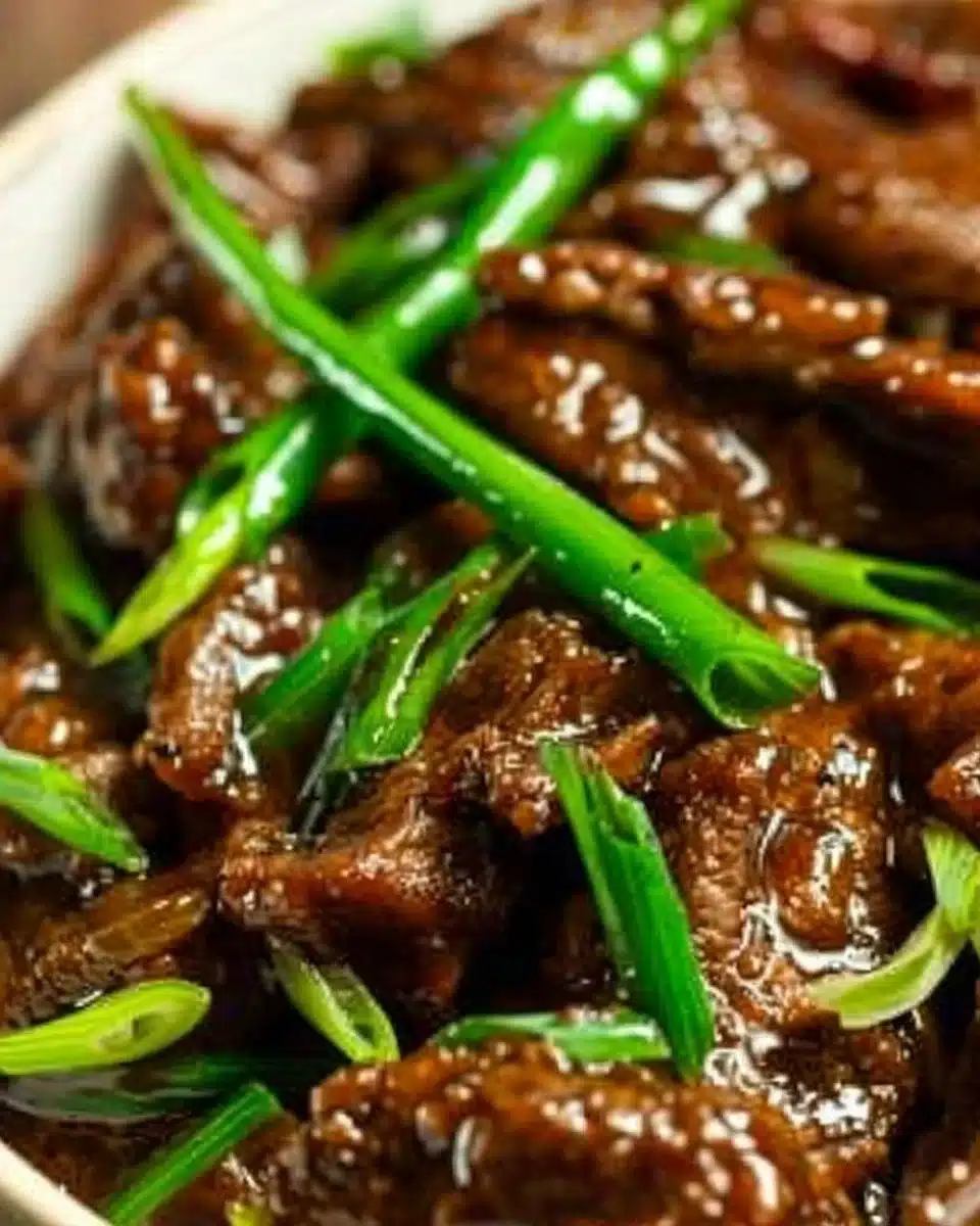 Delicious Slow Cooker Mongolian Beef dish served with rice and vegetables.