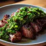 Gourmet garlic scape chimichurri sauce in a bowl with fresh herbs