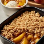 Juicy peach crisp topped with crunchy oatmeal, fresh peaches, and served warm.