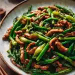 Delicious Pork Stir-Fry with garlic scapes cooked in a vibrant dish