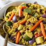 Couscous with Roasted Vegetables topped with fresh herbs and lemon dressing.