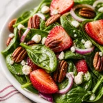 Delicious Strawberry Spinach Salad with pecans, feta, and balsamic dressing.