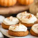 Delicious pumpkin cookies topped with creamy frosting, perfect for fall treats.
