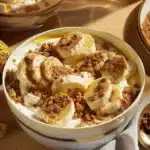 Creamy Biscoff banana pudding topped with cookie crumbles in a dessert bowl