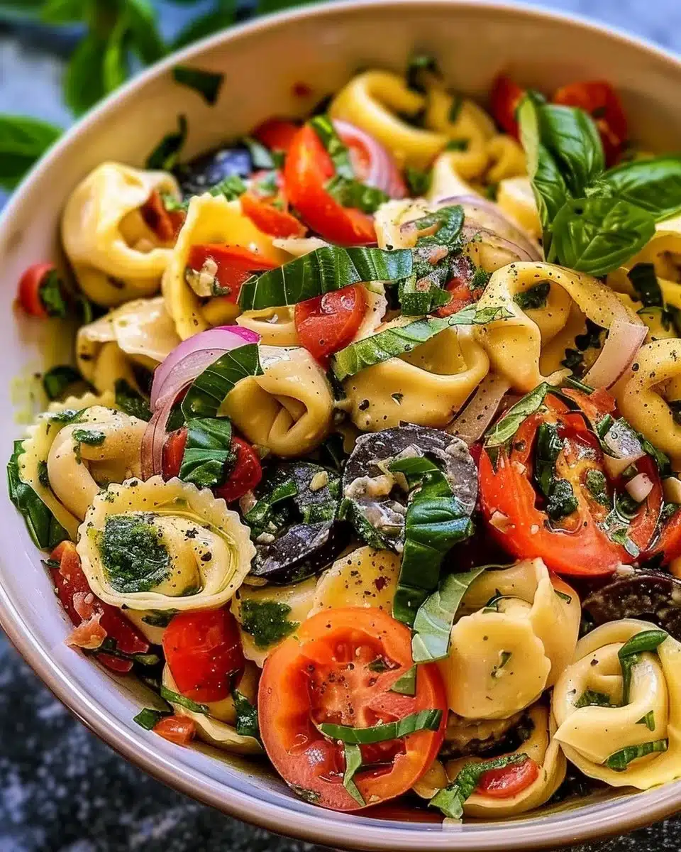 Colorful tortellini pasta salad with fresh vegetables and dressing